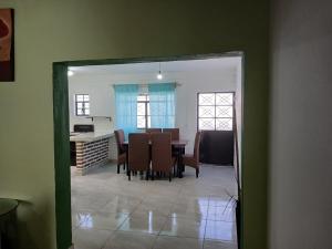 a dining room and kitchen with a table and chairs at Casa Rousse in Tequila