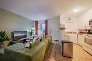 a living room with a couch and a table at Vibrant Modern Escape, Walk To Dining, Near Beach in Sarasota +14 photos