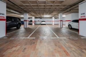 a parking garage with two cars parked in it at BYPILLOW Castellana in Madrid