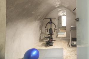 a room with a gym with a exercise bike at TWO VAULTS, Rethymno old town in Rethymno Town
