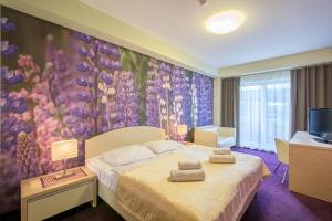 Posteľ alebo postele v izbe v ubytovaní Hotel Slovan