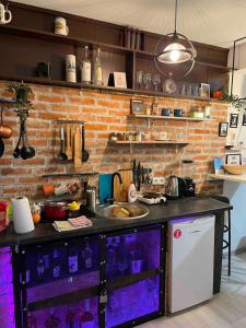 a kitchen with a sink and a brick wall at Park Apartment in Foča +21 photos