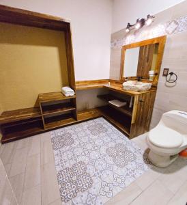 a bathroom with a toilet and a sink and a mirror at Casa del Arbol in San Blas +25 photos