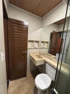 a bathroom with a toilet and a sink at 09 Kitnet próximo da praia com ar-condicionado in Maceió +59 photos