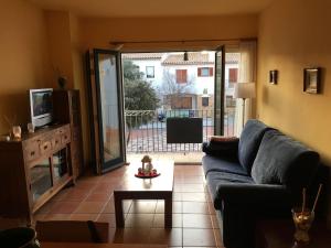 a living room with a couch and a tv at Apartament Antic Plankton - Calella Palafrugell - Free Parking, Beach, Wifi, Perfect holidays in Calella de Palafrugell