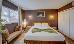 a bedroom with a bed with a bow tie on it at Vibrant Modern Escape, Walk To Dining, Near Beach in Sarasota