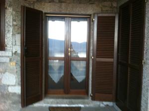 a door leading to a balcony with a view at Appartamenti Monterosso in Verbania