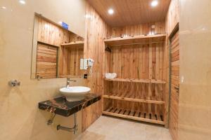 a bathroom with a sink and wooden walls at Hamilton palace in Lansdowne +42 photos