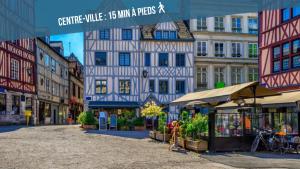 a city street with buildings and a sign that reads centre rule mins at VOYAGE AU CALME à 10 Minutes du centre avec PARKING INCLUS et FIBRE, IDÉAL SOLO et PRO in Rouen