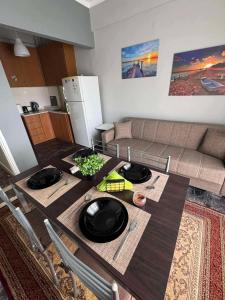 a living room with a table and a couch at Sunset Sea Apartment in Alexandroupoli +5 photos
