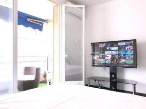 a bedroom with a flat screen tv on a wall at Luxury Studio YourHostHelper in Cannes +2 photos