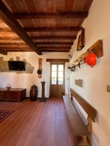 a living room with a wooden ceiling and a tv at IVO house in Vezza