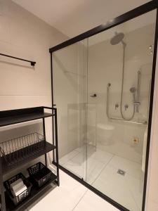 a bathroom with a shower with a glass door at Flat Premiun Vila Madalena in Sao Paulo