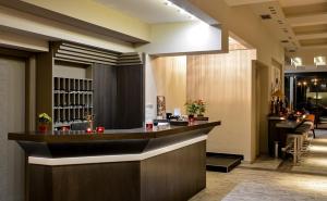 a bar in a hotel lobby with a counter at Porto Del Sol Hotel in Paralia Katerinis