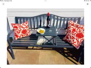 a blue bench with pillows and a bottle of wine at Lovely guest suite in country villa near Cologne in Kerpen +26 photos
