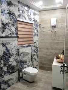a bathroom with a toilet and a sink at Luxury One bedroom Apartment R1 in Lomé