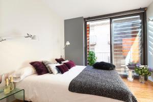a bedroom with a large bed and a large window at My Space Barcelona Guell Terrace Center in Barcelona