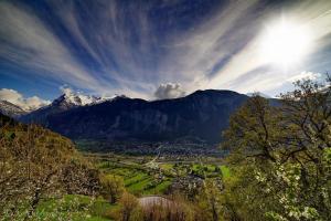 a view of a valley with mountains in the background at Le mas des Alberges in Le Bourg-dʼOisans