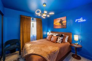 a blue bedroom with a bed and a blue wall at Dollhouse Daydream! Barbie-Inspired Home in Peoria +33 photos