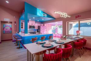 a pink and blue kitchen with a table and chairs at Dollhouse Daydream! Barbie-Inspired Home in Peoria