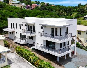 an aerial view of a white house with balconies at Lemongrass Condos in Gros Islet
