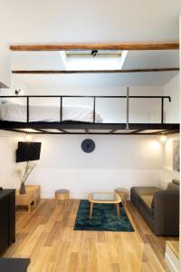 a living room with a loft bed and a couch at Studio 5 mn from Arc de triomphe - Champs-Élysées in Paris