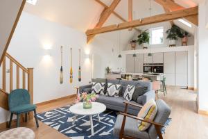 a living room with a couch and a table at 2 Bed Converted Barn in Ombersley