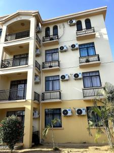 an apartment building with balconies and air conditioners at Apartamento Condomínio Vila Flor in Viana