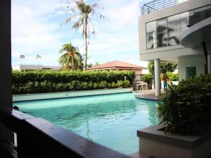 a swimming pool in front of a building at One Spatial Condo in Iloilo City