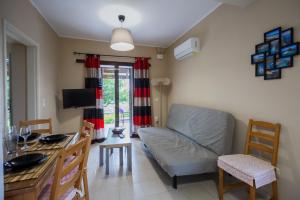 a living room with a couch and a table at Aggerikos Relax House in Ayios Kirikos