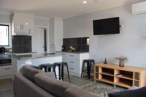 a living room with a couch and a kitchen at Country Style Accommodation Unit 2 in Ouyen