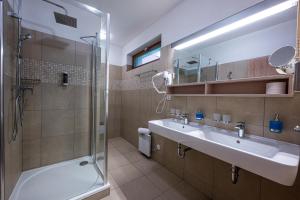 a bathroom with a sink and a shower at Horský hotel Lorkova vila in Čeladná +21 photos