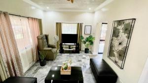 a living room with a couch and a tv at Abucay Guests House in Utap