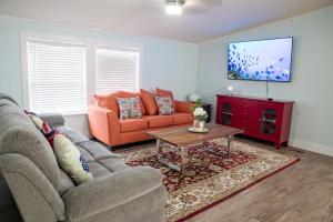 a living room with a couch and a table at R3 Orange at Inlet Beach with Pool, EV Connector and RV Parking in Inlet Beach