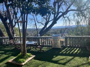 a balcony with a swing and a table and chairs at Specious 6000 sf privat gated villa with View in Fremont