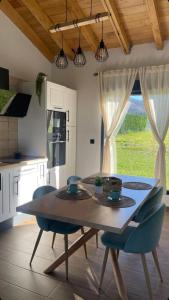 a kitchen with a wooden table with chairs and a dining room at casa maria in Barcia