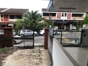 a wrought iron fence in front of a house at Rumah Teres Teluk Kumbar in Bayan Lepas