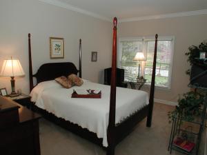a bedroom with a bed with two shoes on it at The Garden Inn Bed & Breakfast at Bee Rock in Monterey +19 photos