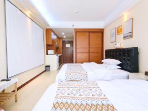 Voodi või voodid majutusasutuse Guangzhou Uhome Service Apartment toas