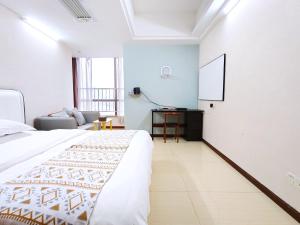 Voodi või voodid majutusasutuse Guangzhou Uhome Service Apartment toas