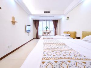 Voodi või voodid majutusasutuse Guangzhou Uhome Service Apartment toas