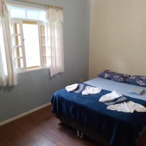 Postelja oz. postelje v sobi nastanitve Casa em Florianópolis pé na areia com sauna