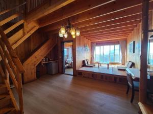 a large room with a staircase in a wooden house at Top Cloud Villa in Renai