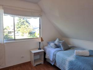 a bedroom with a bed and a window at Desayuno, Cómodo, ideal para Familia y Trabajo in Osorno +9 photos