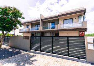 a house with a gate and a fence at Salty Breeze in Flic-en-Flac