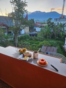 a plate of food on a table with a view at Rumah Mawar Syariah in Bukittinggi