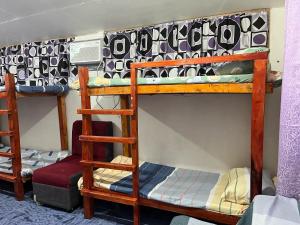 a group of bunk beds in a room at Zia"s homestay-3 in Cangalwang