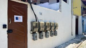 a wall with a bunch of electrical equipment on it at La Mar Paraty Hospedaria 06 in Paraty +1 photo