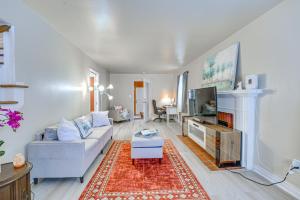 a living room with a couch and a tv at 15 Mi to Dtwn Detroit Cozy Family Home with Yard! in Detroit