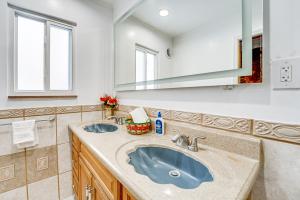 a bathroom with a sink and a mirror at 15 Mi to Dtwn Detroit Cozy Family Home with Yard! in Detroit +21 photos